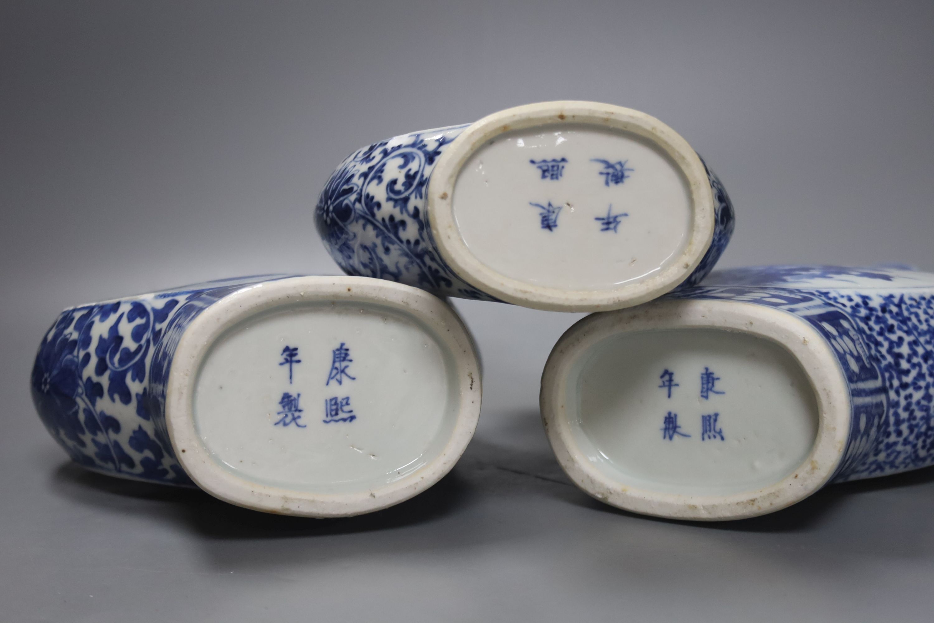 Three 19th century Chinese blue and white Moon flasks, tallest 31 cms.